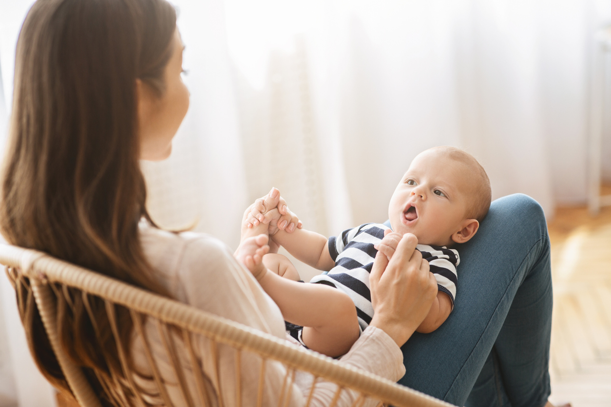 Mother speaking to young baby boy