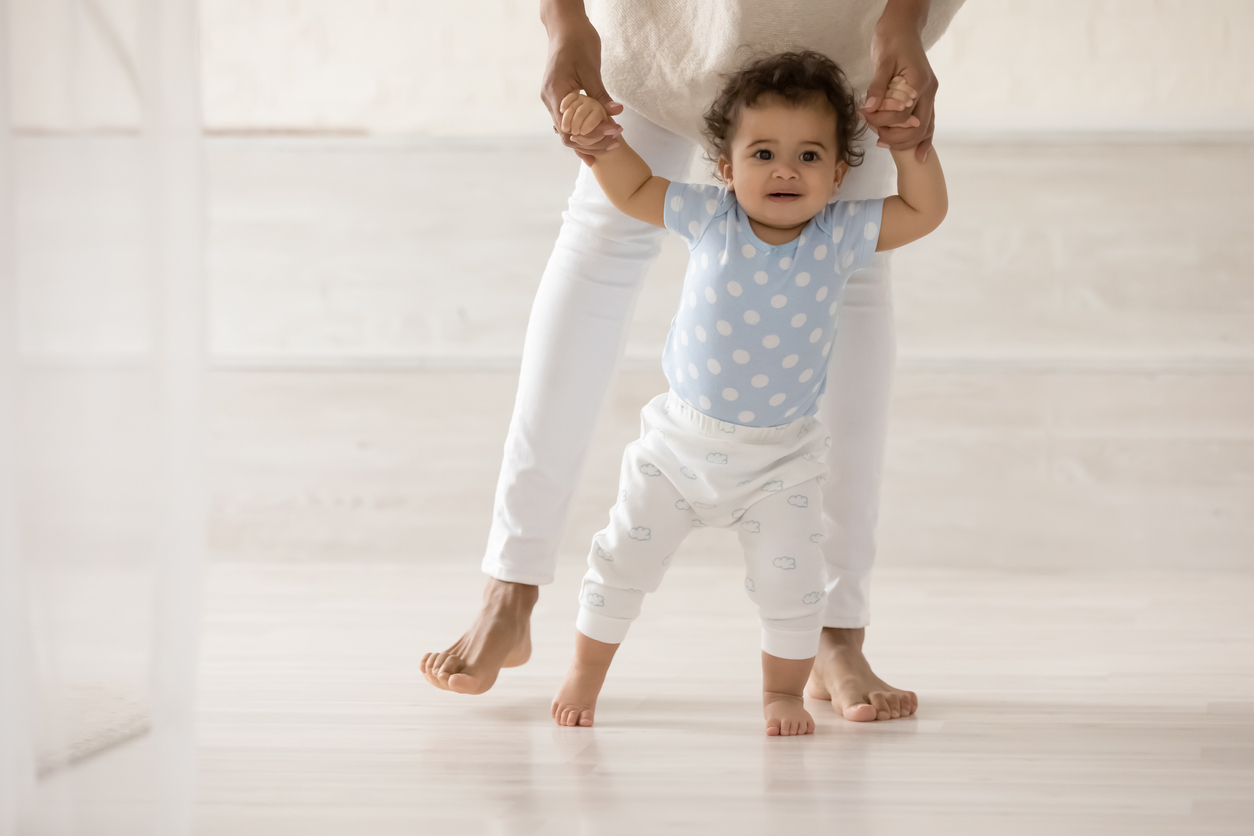 family helping toe walking baby