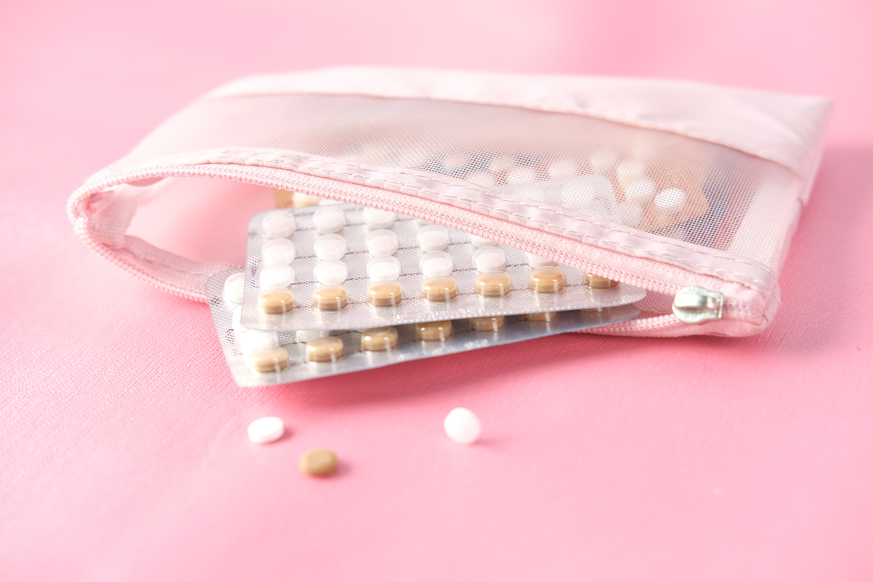 Birth control pills on pink background, close up stock photo