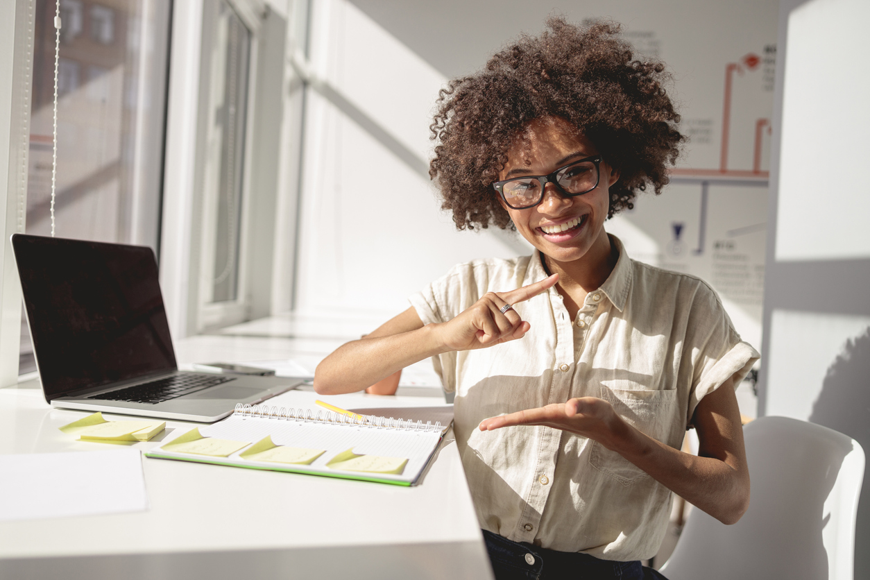 Woman using laptop to learn sign language