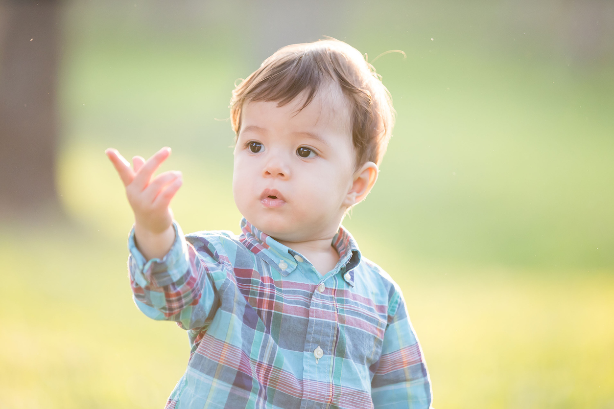 Baby boy using his hands to communicate