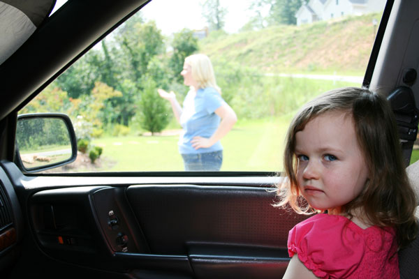girl waiting in car for mom
