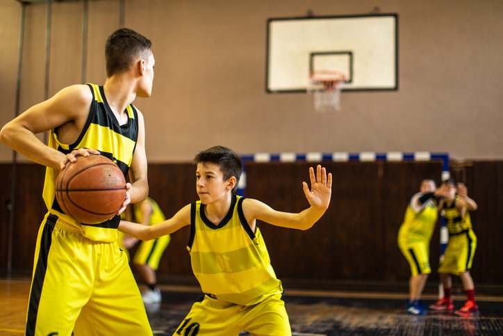 Teenage basketball team plating friendly match at indoors basketball court stock photo