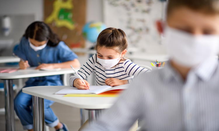 Students in masks return to school during pandemic