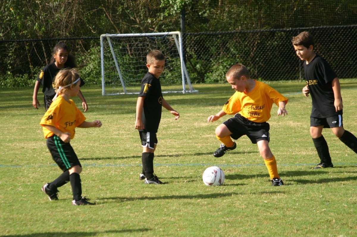 Helping childhood obesity - kids playing soccer