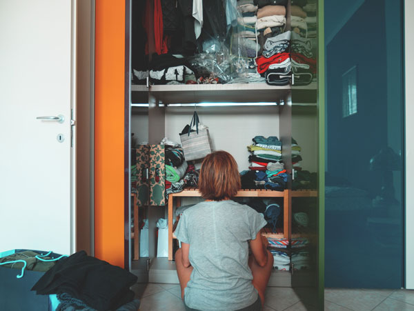 woman cleaning out closet before baby comes