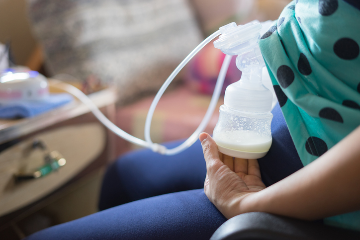 a new mom pumping milk with a breast pump 