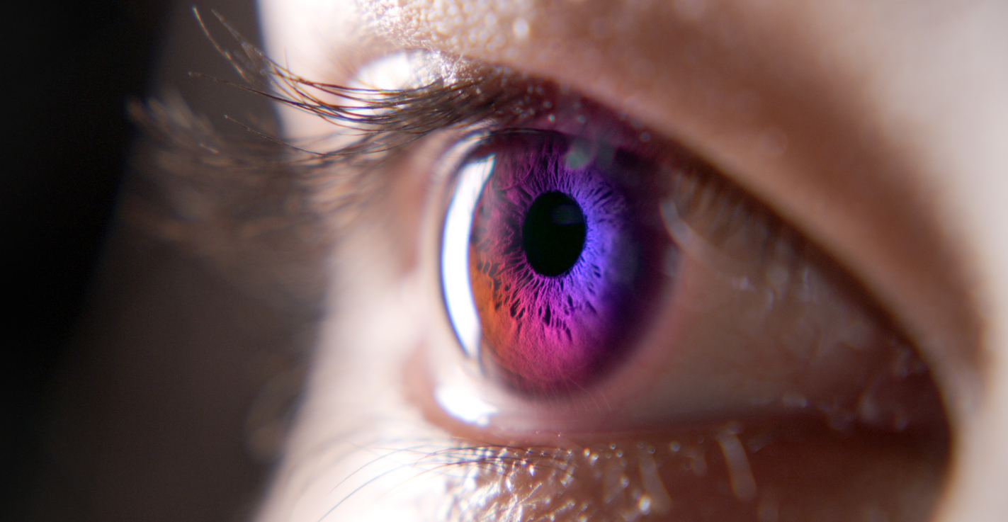 Cropped shot of a teenage girl’s eye in all the colours of the rainbow against a black studio background