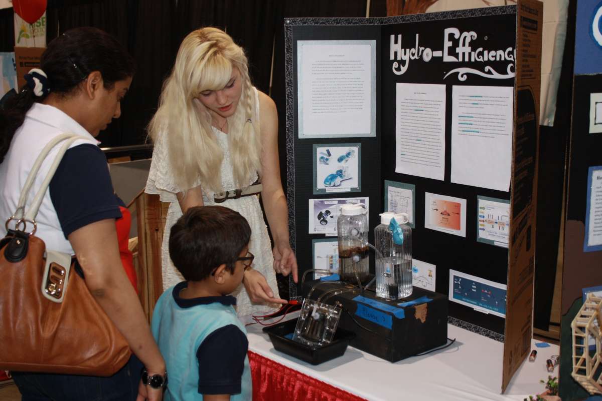 A child shows off his science fair invention for National Inventors Month