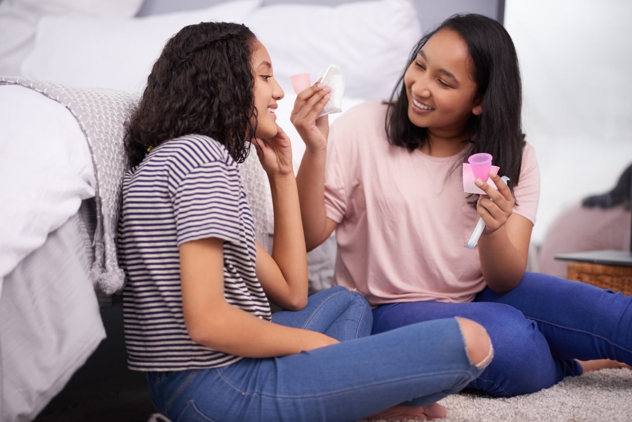 Two teenage girls discuss menstruation