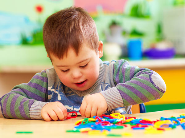 young autistic boy playing