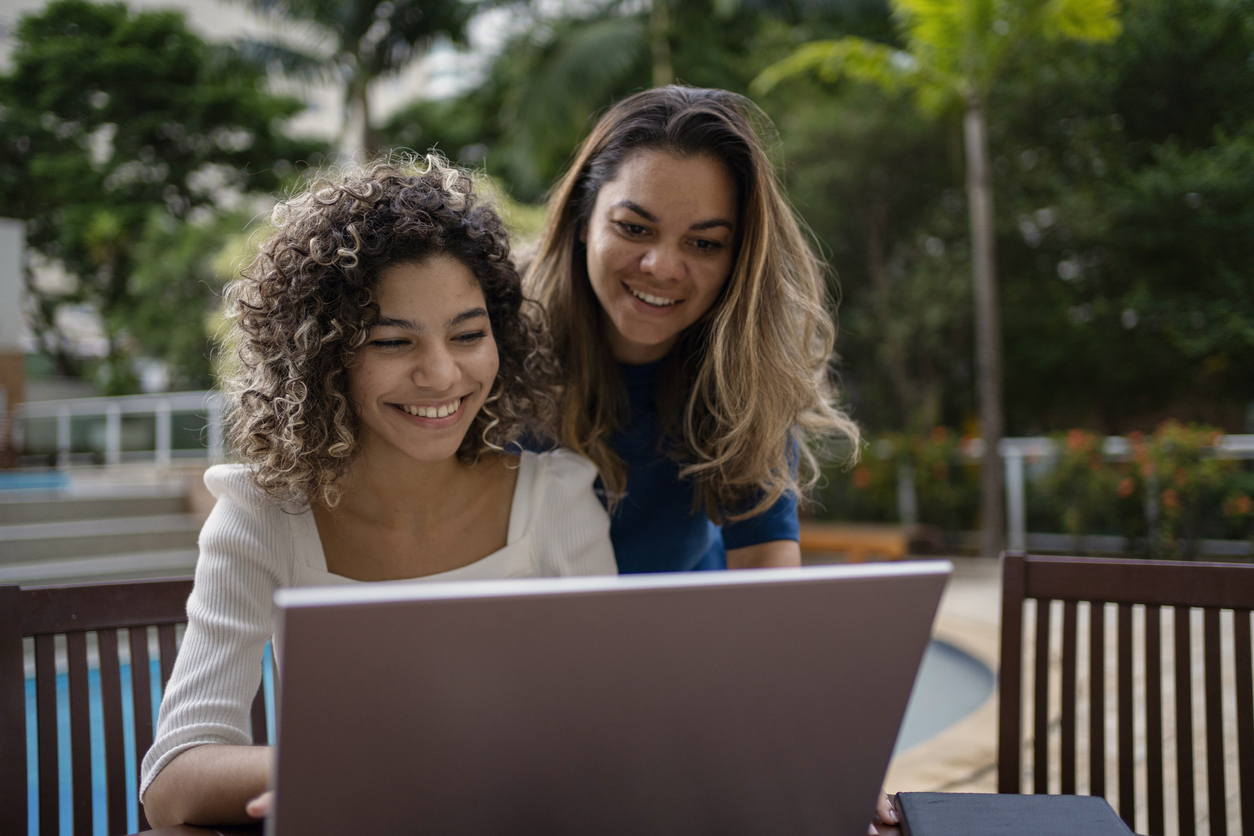 Mother and teen daughter looking at investing tips online