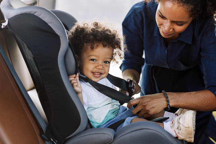 young toddler in a car seat 