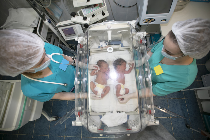 newborn twins in a hospital delivery room 