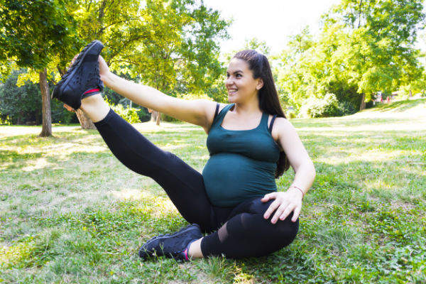 athletic pregnant woman in park