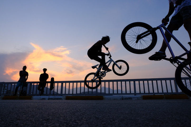 boys jumping on bikes