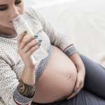 woman drinking water to help urinary tract infection during pregnancy