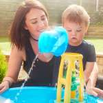 mom and son playing water table activity