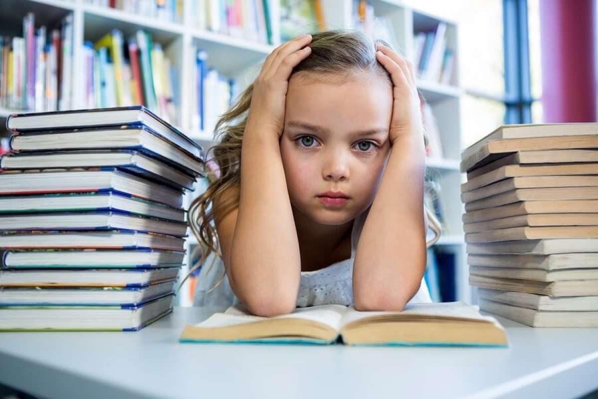 Stressed Young Girl with Stack of Books