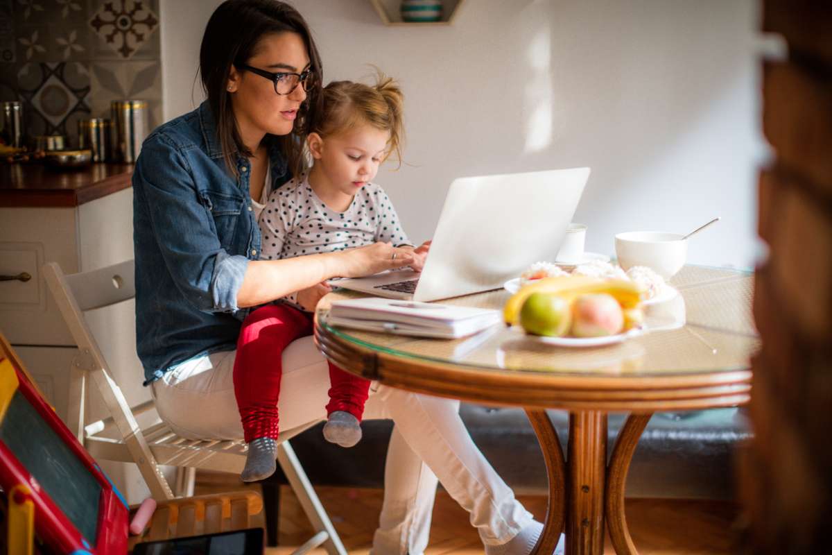 mom working on side hustle at home with toddler