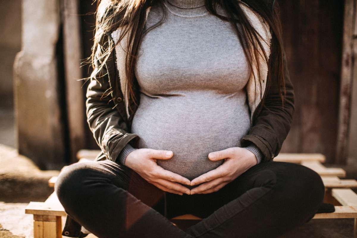 pregnant woman holding belly