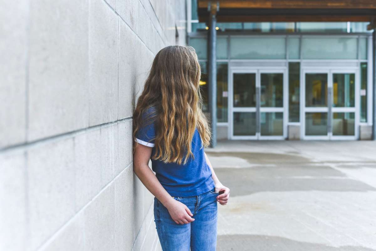 Teenage girl looking over her shoulder at school