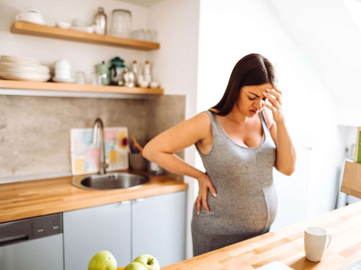 woman experiencing migraine during pregnancy