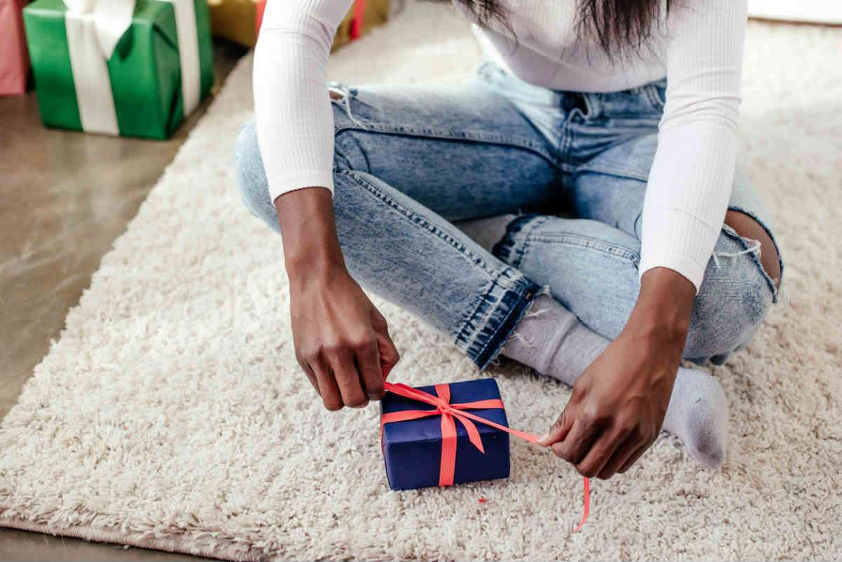 teen girl opening stocking stuffer gift