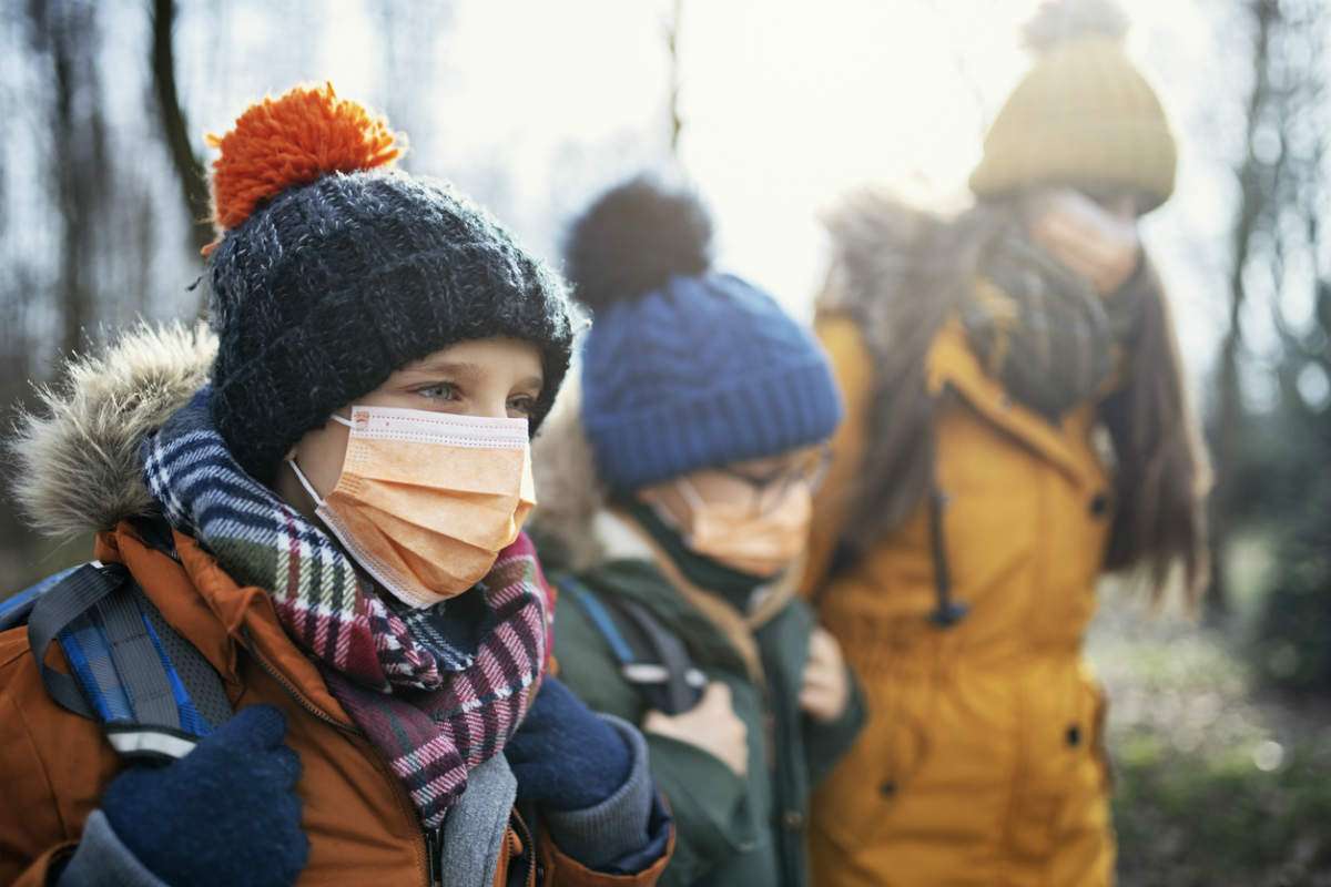 family wearing mask to protect against coronavirus
