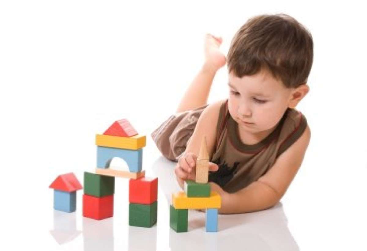 Young boy playing with building blocks
