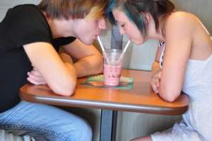 Teen Couple Sharing Milkshake