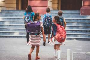 kids at school wearing backpacks