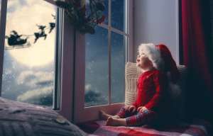 baby looking out at window wondering "is santa is real?"