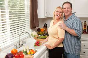 Keeping Your Husband Healthy, Married couple cooking heart healthy meal for mans diet