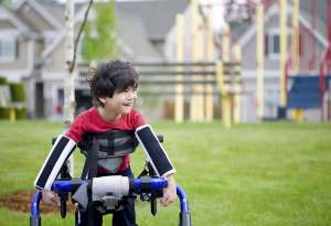 Young happy boy in wheelchair