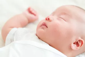 Newborn baby sleeping on back