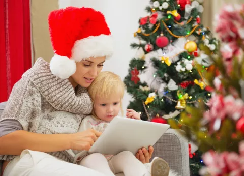 mother and child Facetime using tablet on Christmas