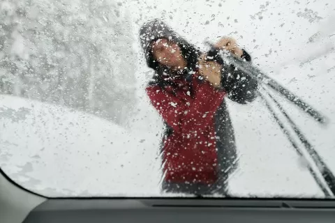 Teen Cleaning Off Icy Windshield Wiper