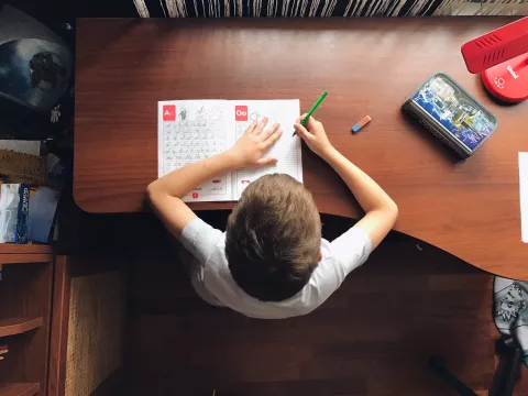 homeschooled child working on schoolwork at home