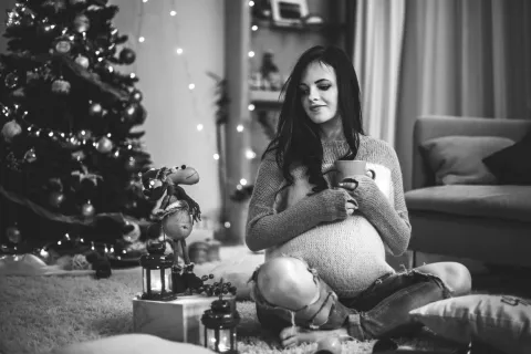 pregnant woman sitting at home during christmas