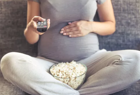 pregnant woman watching the Oscars 