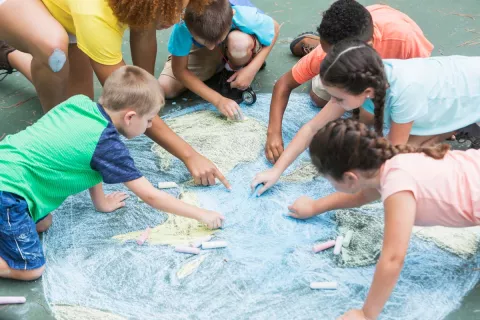 kids doing earth day crafts with chalk