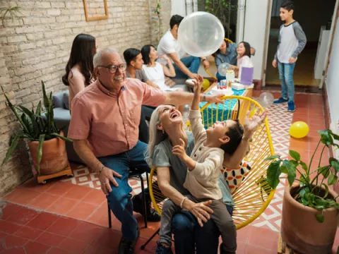 Family spending time with each other and playing with balloons at family reunion