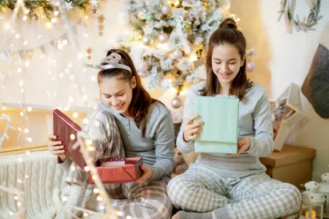teenage girls opening Christmas gifts