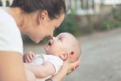 new mother holds her baby