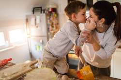 kid and mom having fun in the kitchen