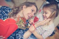 child giving her mother a sweet mother's day gift