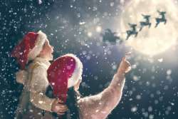 mom and daughter watching santa in sky