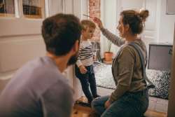 parents measuring baby's height