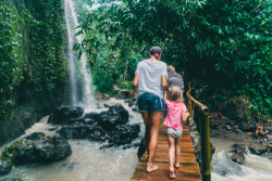 Family hiking near a waterfall on vacation 